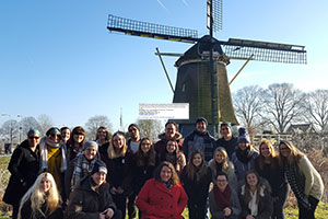 Psychology students in front of a windmill in Amsterdam, January 2017. Photograph by tour guide. Psychology students in front of a windmill in Amsterdam, January 2017. Photograph by tour guide.